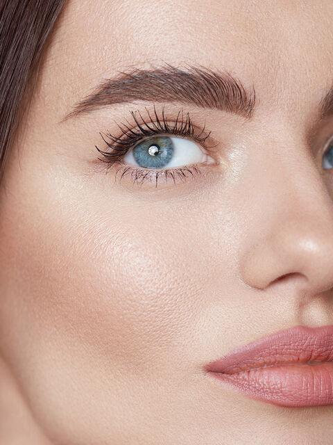 Close-up of a woman's face with full cheeks and smooth skin